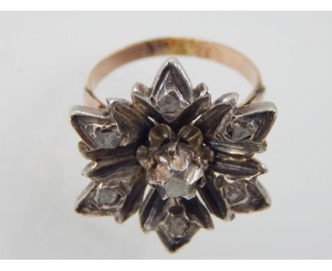 A Maltese diamond set ring, the floral mount, set in a yellow metal band, 6g.