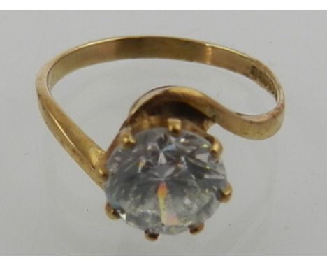 A 9 carat yellow gold and round cut cubic zirconia single stone ring.