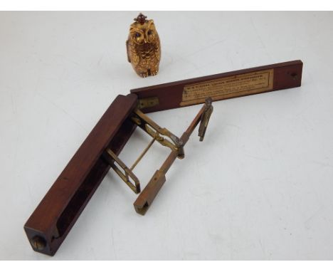 A novelty embossed brass double sovreign case modelled as an owl, H. 6cm, together with a set of Victorian mahogany cased bra