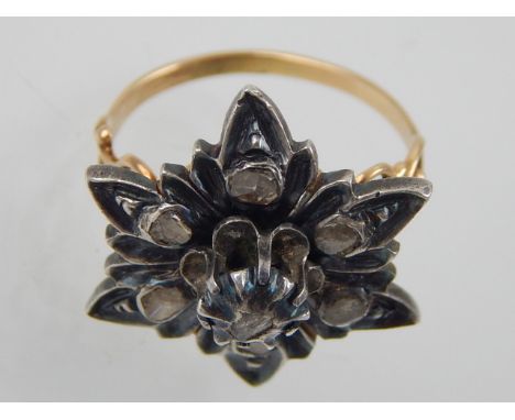 A Maltese diamond set ring, with a floral white metal mount, in a pierced yellow metal band, 6.5g.
