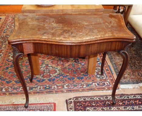 A George III mahogany card table, the rectangular crossbanded serpentine top above a concertina action, on moulded cabriole l