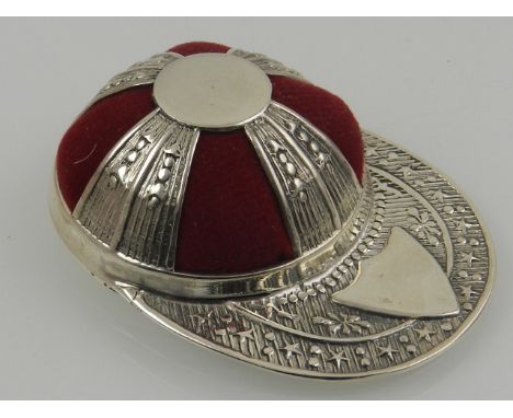 A novelty sterling silver pin cushion in the form of a jockey cap. 