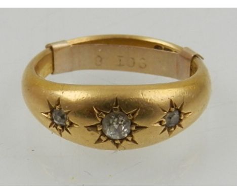 An 18ct yellow gold and diamond set 'gypsy' style ring, set three graduated stones, having removable ring sizer clasp within 