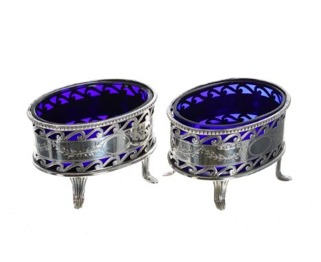 Pair of&nbsp;George V&nbsp;silver open salts, the scrolling pierced baskets with engraved foliate swag borders enclosing blue