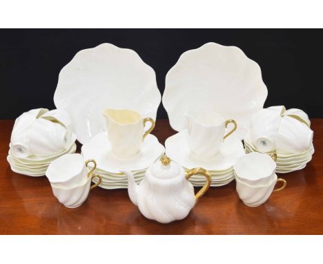 Coalport porcelain tea wares, white with gilt handles, in fluted spiral form; comprising two cream jugs, twelve teacups and s