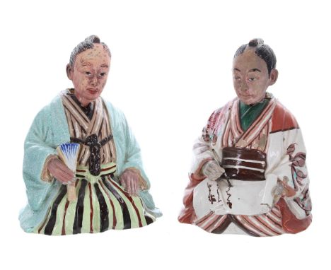 Two Chinese glazed stoneware figures modelled as seated gentlemen, one with a fan, the other with a pen and scroll, both with