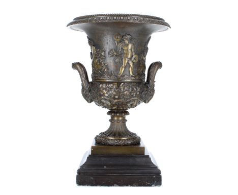 Good decorative bronze campagna urn, decorated with putti and fruiting vine, with twin rams head handles, mounted upon a step