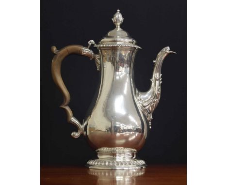 George III silver pear shaped coffee pot,&nbsp;with a fruitwood handle and hinged cover with an acorn finial and gadrooned bo