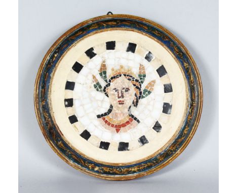 A FRAMED CIRCULAR MOSAIC PANEL in a blue gilded frame. 9ins diameter overall.
