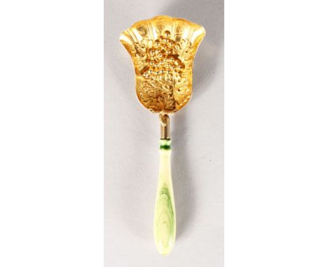 A VICTORIAN SILVER GILT CADDY SPOON, the bowl with fruiting vines and turned ivory handle. 11cms long.  Birmingham 1854.  Mak