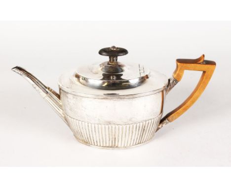 A VICTORIAN OVAL SEMI GADROONED TEAPOT with wooden handle and finial. London 1880.  Maker: J.A. & J.S.  Gross Weight 12ozs.