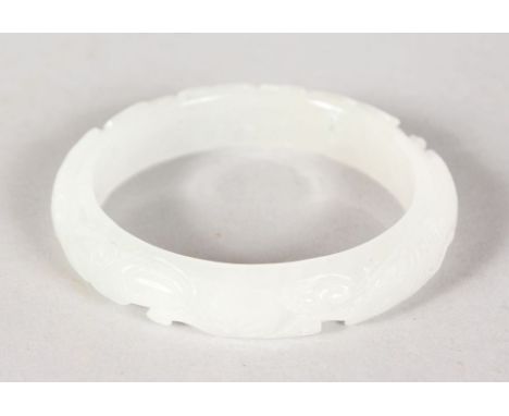 A GOOD CARVED WHITE JADE BANGLE.