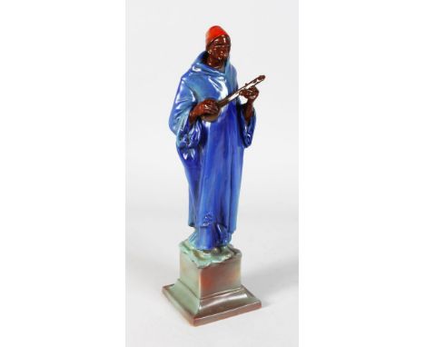 A ROYAL DOULTON FIGURE OF A MOORISH MINSTREL, designed by C. J. NOKE, painted by Doulton & Co., No. 341, HN34, Issued 1913-19