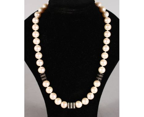 A STRING OF 38 PEARLS with diamond and enamel sections.