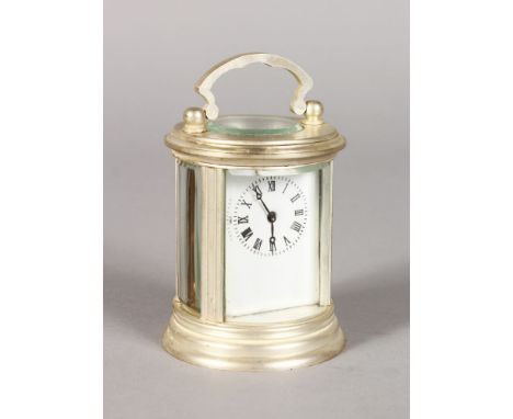 A SILVER PLATE CIRCULAR CARRIAGE CLOCK. 3ins high.