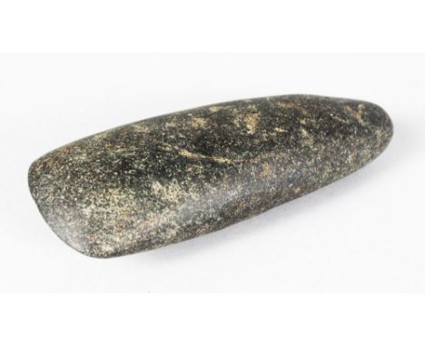 A NEOLITHIC AXE HEAD. 6.25ins long.