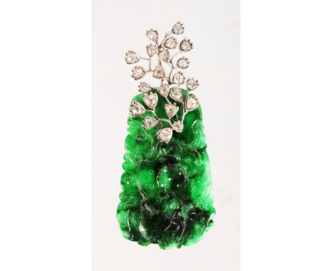 A SUPERB CARVED JADE PENDANT, carved with bats, set in twenty-two diamonds.