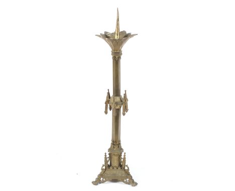 A Victorian Neo-Gothic gilt metal pricket candlestick. On a hexagonal stand with a fluted drip pan and various applied orname