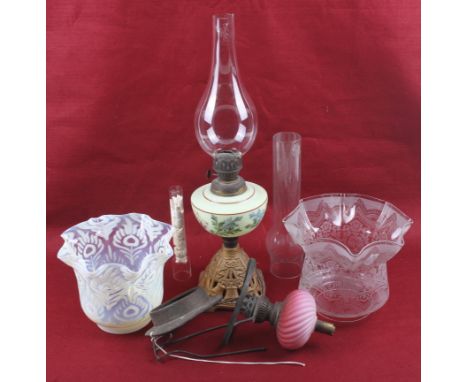 A collection of vintage oil lamp components. Consisting of an oil lamp with a painted reservoir, (the funnel has a chip), a v
