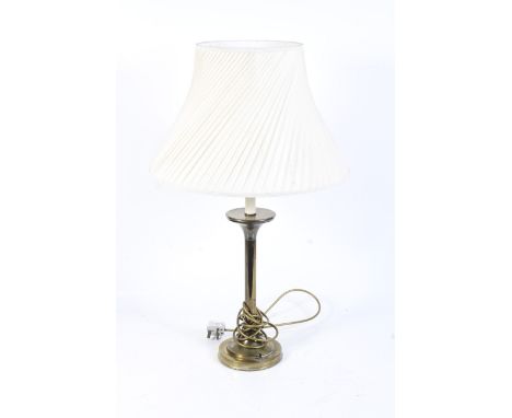 A 20th century brass desk lamp. Mounted on a stepped circular base, with a cream fabric shade, H52cm (excluding fittings)