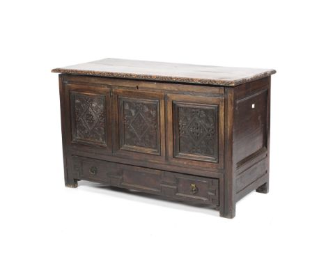 A late 17th/early 18th century oak mule chest. With three carved panels, later carved top edge, drawer under, opening to reve