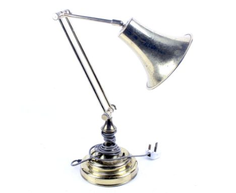 A vintage brass desk lamp. With an adjustable stem, mounted on a stepped circular base, Max. H80cm