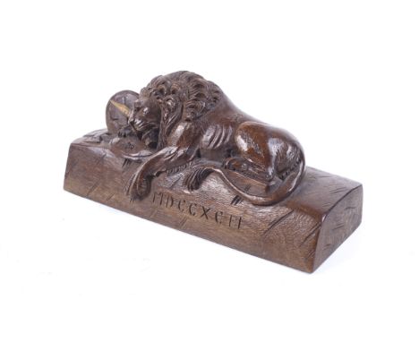 A vintage 'Lion of Lucerne' wood carving. Carved with Roman numerals to the front for the year 1792. L16.5cm.The Lion of Luce