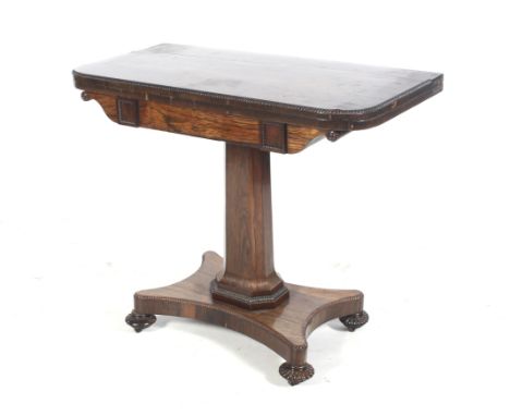 A Regency dark rosewood (almost coromandel) pedestal foldover card table. With gadrooned edges to top, squared sections (and 