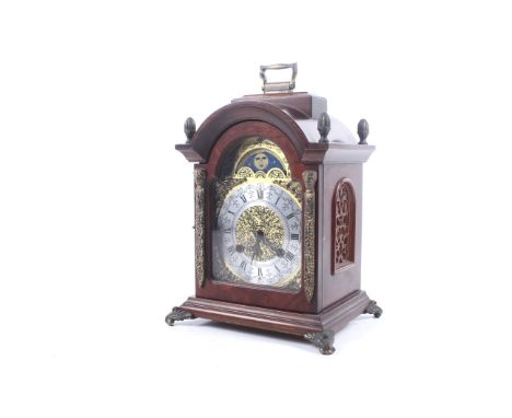 A Dutch 20th century 8 day striking bracket clock. With a Franz Hermle mechanism, striking to two bells. Arched brass dial wi