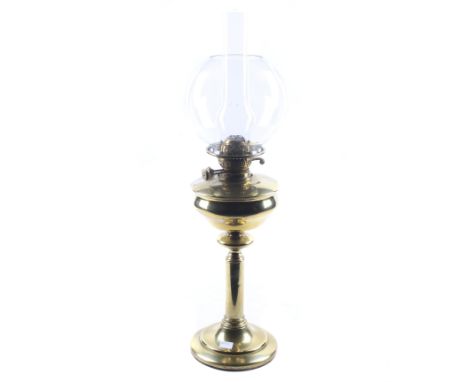 A Edwardian brass oil lamp. With a straight cylindrical column on a stepped circular base, clear glass chimney and shade. H70