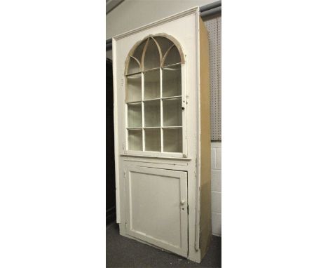 A Georgian, white painted pine alcove wall cupboard. Panelled cupboard door below a pull out shelf and a multi glazed panel a