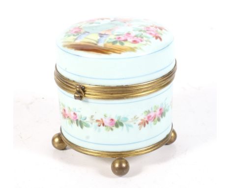 A late 19th/early 20th century circular trinket box and cover. Decorated with an image of a young boy and hand painted flower