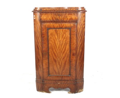 A 19th century Dutch floor standing corner cabinet. A lockable 'Bombe' shaped drawer above a single solid panelled door, with