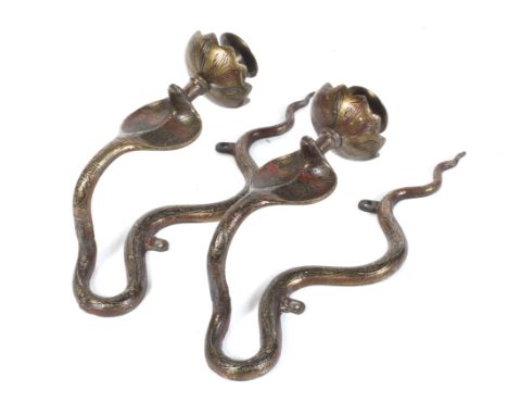 A pair of early 20th century Indian Benares wall sconces. Modelled as cobras, with red and black enamel details applied to th