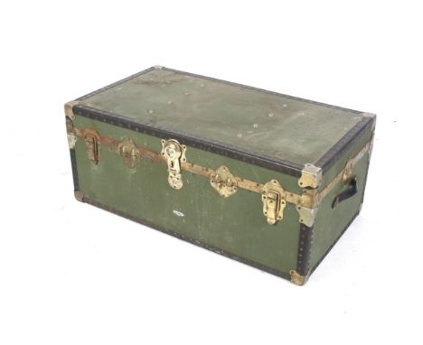 A 20th century steamer travel trunk. With metal bound corners, reinforced edges held with stud work, metal clasps and substan