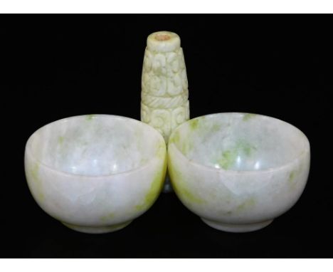 Two oriental hardstone jade white bowls, each with green inclusions, 5.5cm Dia. and a carved rectangular pendant or bead, 6.5