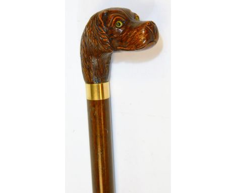A 20thC walking stick, with carved dog head and plain cylindrical stem with metal collar, 88cm H.  