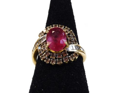 A ruby and diamond dress ring, with central oval cut ruby, in four claw setting, surrounded by two rows of round brilliant di