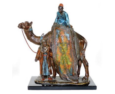 A cast and painted spelter figural table lighter, in the manner of Bergmann, formed as an Arabian rug seller on a camel's bac