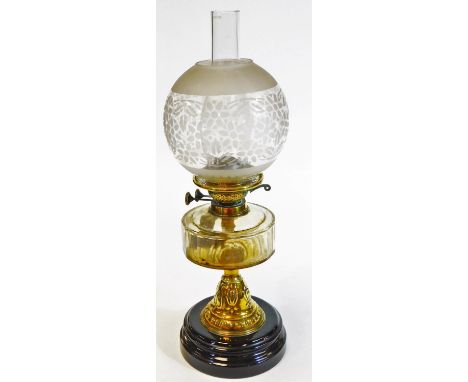 A Victorian brass oil lamp, with clear glass, faceted reservoir, stencilled shade and ceramic base, 57cm H overall.  