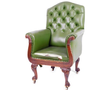 A 19thC mahogany library armchair, with button back arms and seat upholstered in later green leather, on scroll topped hairy 