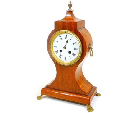 A 19thC mahogany balloon clock, the shaped case on an inverted stem and platform base, terminating in brass hairy paw feet an