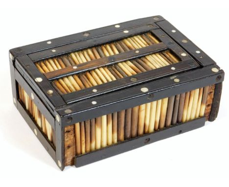 A late 19thC porcupine quill card box, of rectangular form with articulated lid, 12cm W, containing a set of playing cards. 