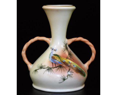 A Royal Worcester Locke &amp; Co two handled blush ivory vase, decorated with a peacock,  green Locke &amp; Co mark, c1890, c