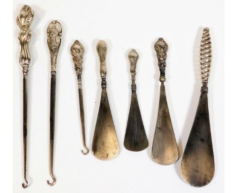 Various silver handled implements, button hooks, shoe horns,  23cm W, etc. some with silver handles.  (a quantity) 