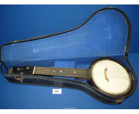 An early 20th century interesting Jetel 4 string Banjo in original black and felt lined case, 21" long.