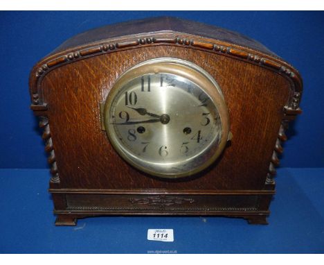 An Oak cased Mantle Clock with barley twist columns and Arabic numerals to face, with key and pendulum, 13" wide x 11 1/2" hi