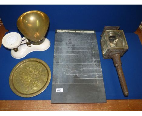 A box of miscellanea including a mid century slate Shove half penny board, Boots brass weighing scales, a coach candle lamp (