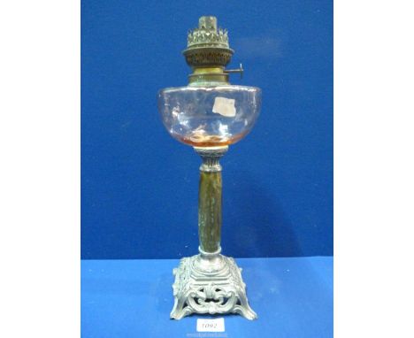 A 19th century oil lamp with coloured glass reservoir above metal pedestal and pierced base, stamped Depose, 16" tall.