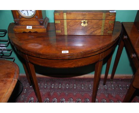 A good early 19th c. demi-lune flap-over card table having boxwood stringing and cross-banding, raised on boxwood beaded tape